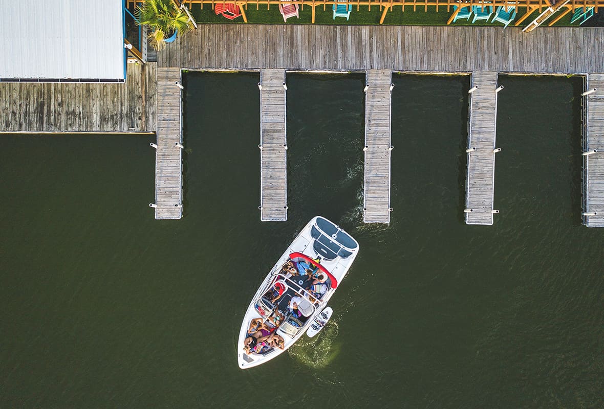 Aerial view of boat leaving marina