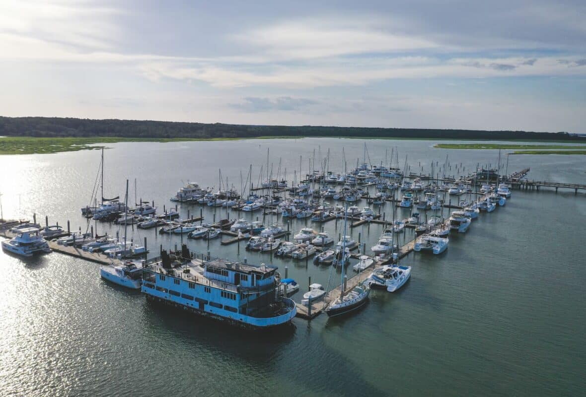 aerial view of skull creek harbor with many boats docked in slips