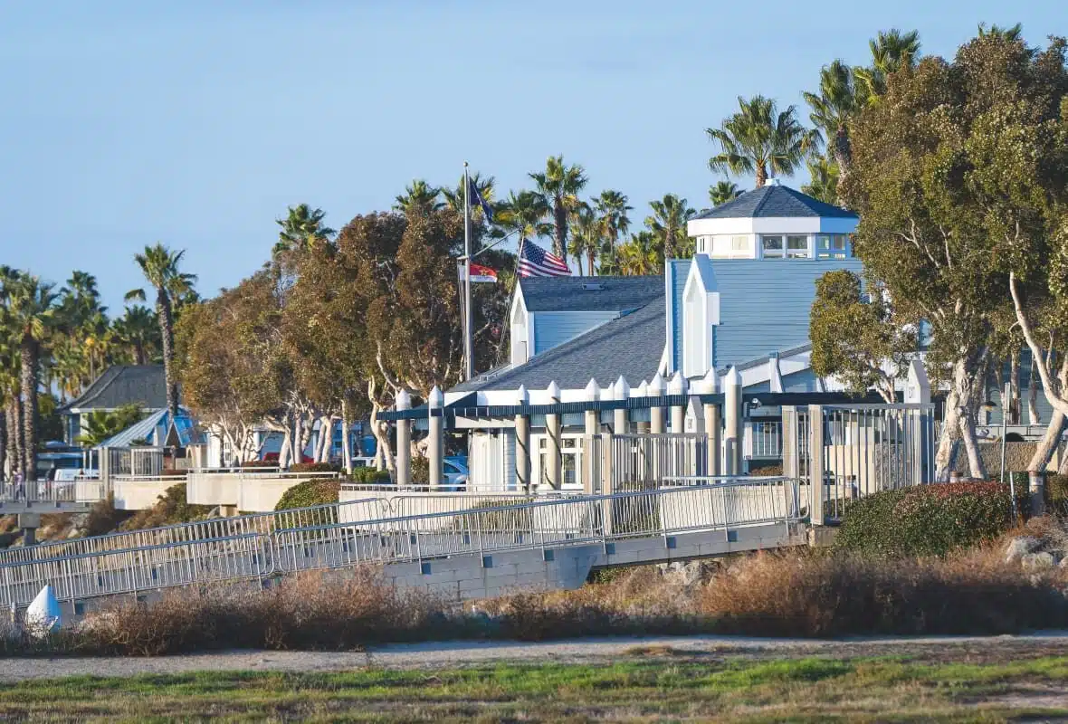 blue and white buildings with flags and a ramp