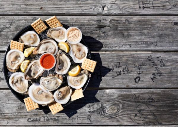 oysters and crackers in a dish on a picnic table