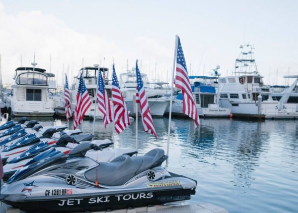 jet skis docked with american flags on the back
