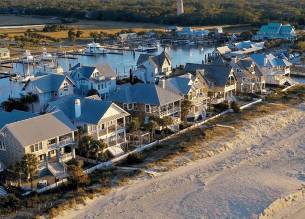 aerial view of large houses by beach