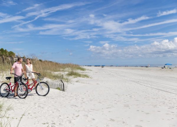 couple with bikes on the beach