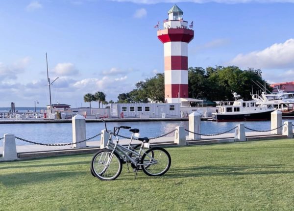 bikes parked in front of pier with lighthouse