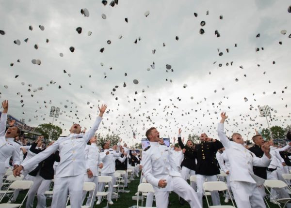 navy graduation and throwing uniform hats