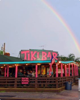 tiki bar outside with rainbow