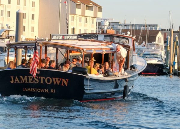 boat that says jamestown on the back with many people on board