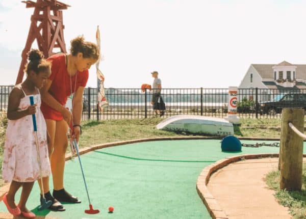 two girls playing mini golf
