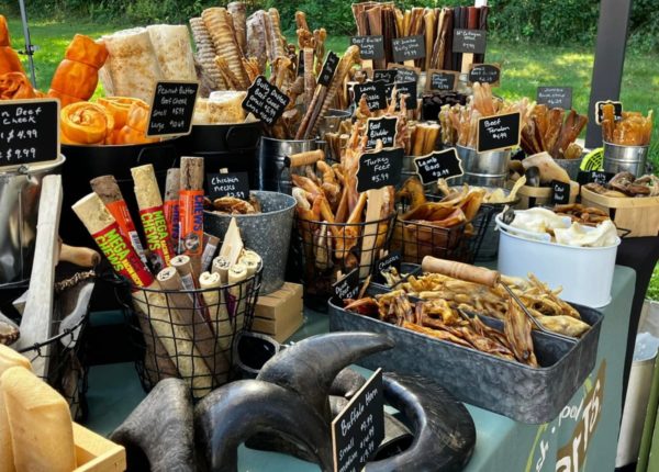 various dog treats and sticks being sold on a table