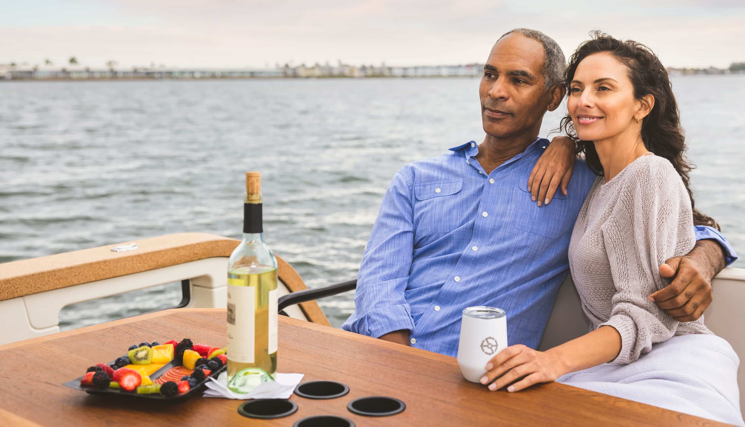 man and woman on boat drinking wine