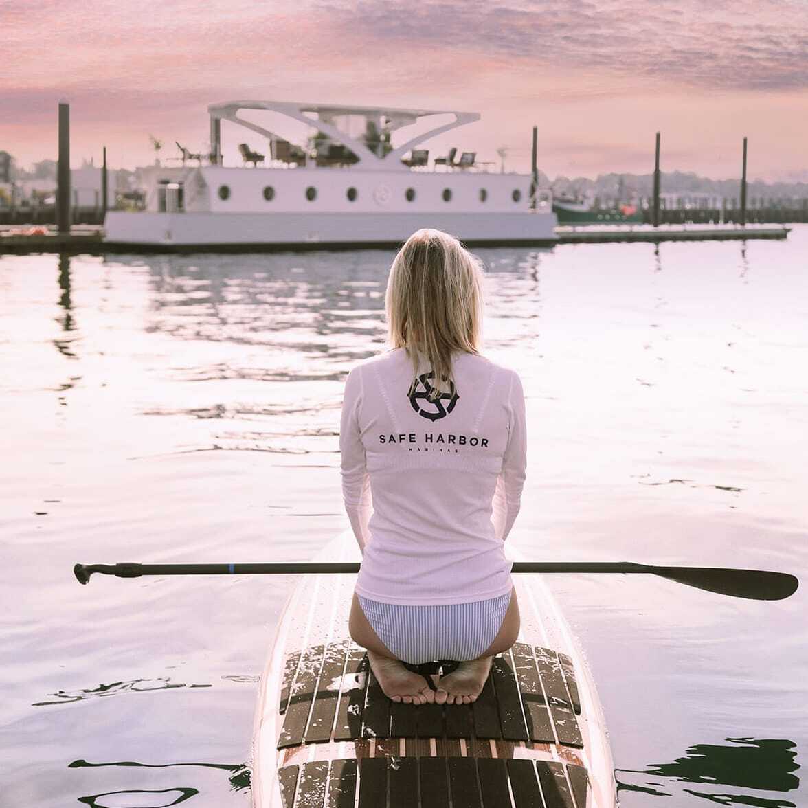 woman sitting on paddle board