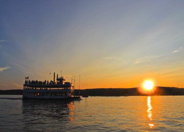 essex steam boat cruising at sunset
