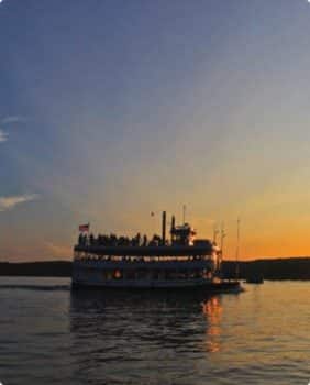 steam riverboat at sunset
