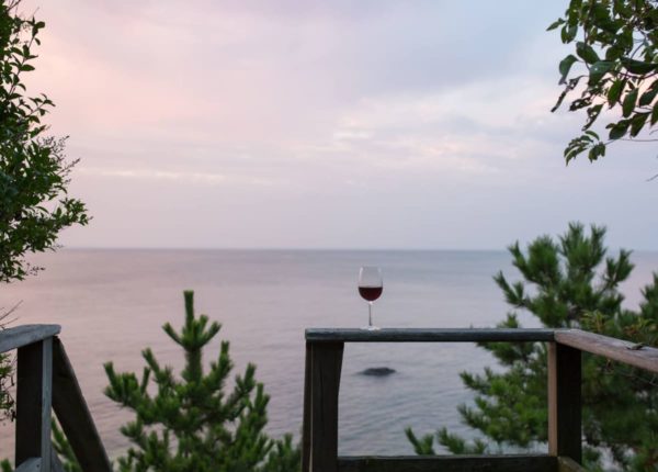 wine glass in front of ocean view at sunset