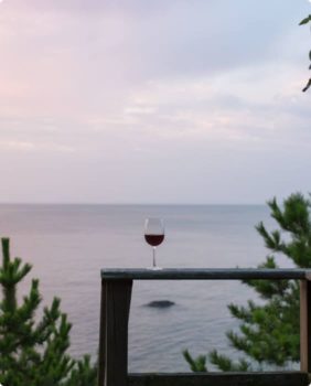 wine glass on a table overlooking water