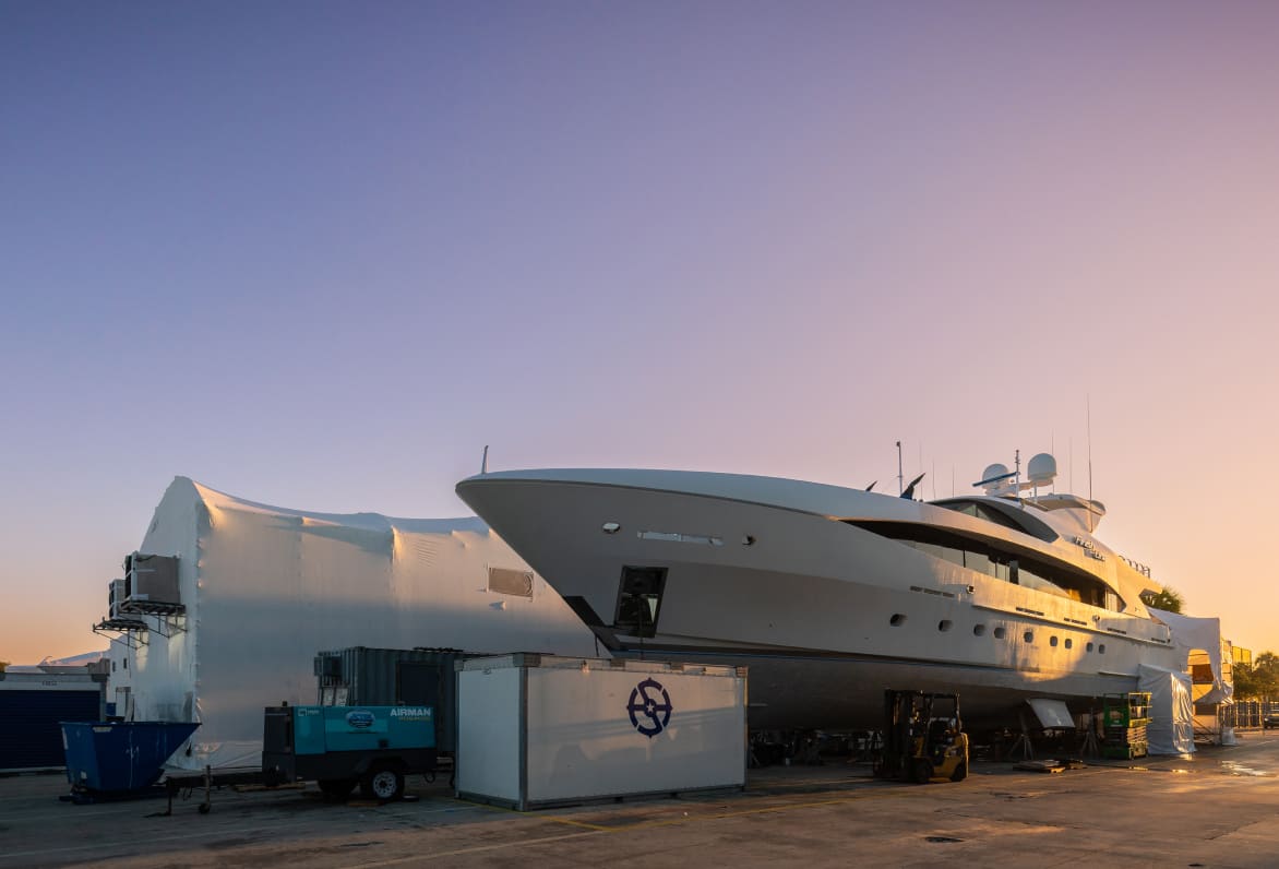 super yacht out of water at sunset ready to be serviced