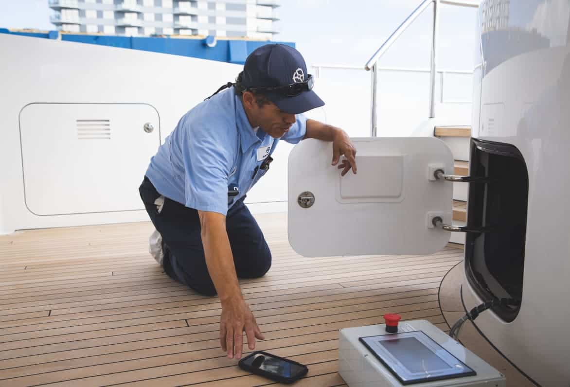 man working on electrical on a yacht