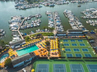 aerial view of marina, tennis courts, pickleball courts, and pool