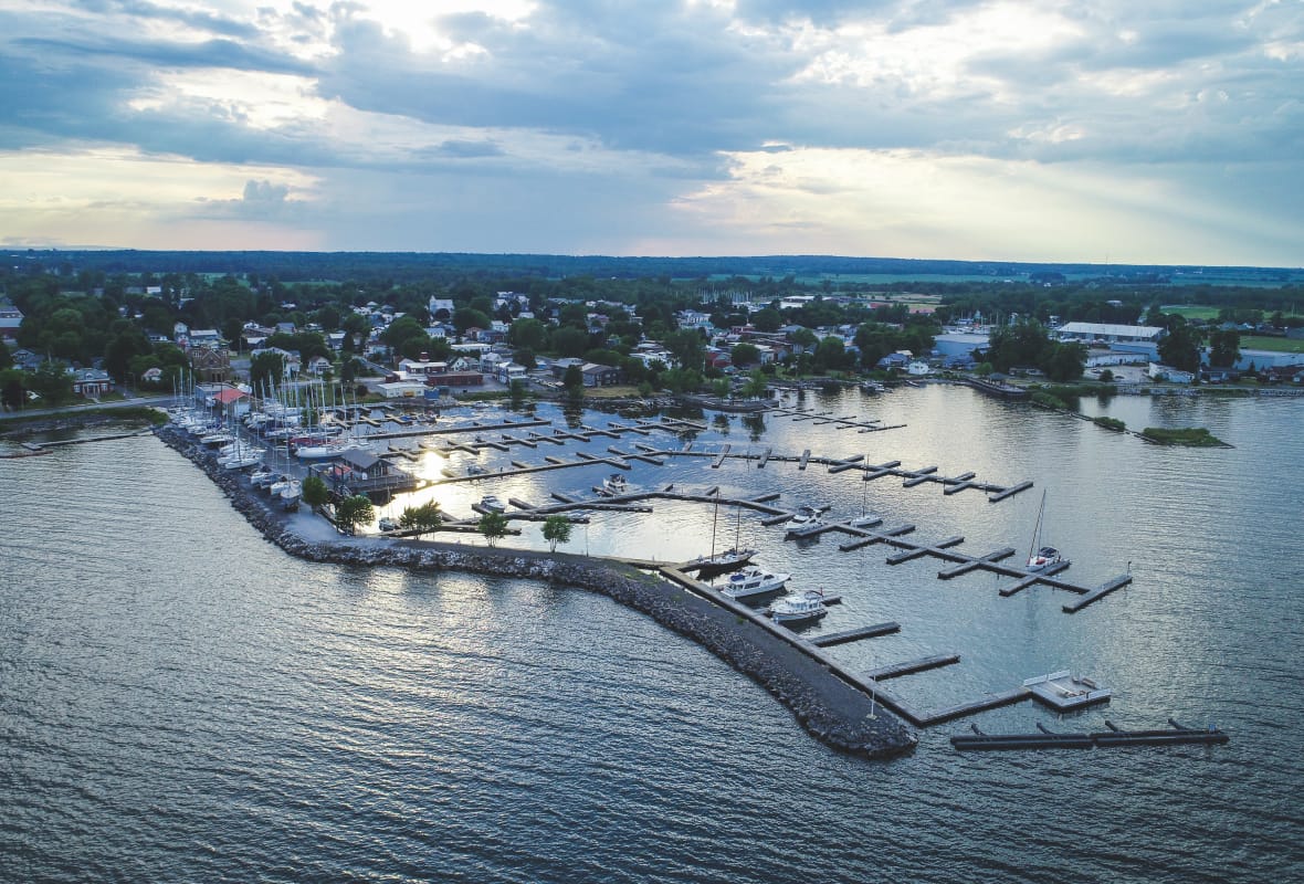 aerial view of marina with a few boats docked with cloudy sky