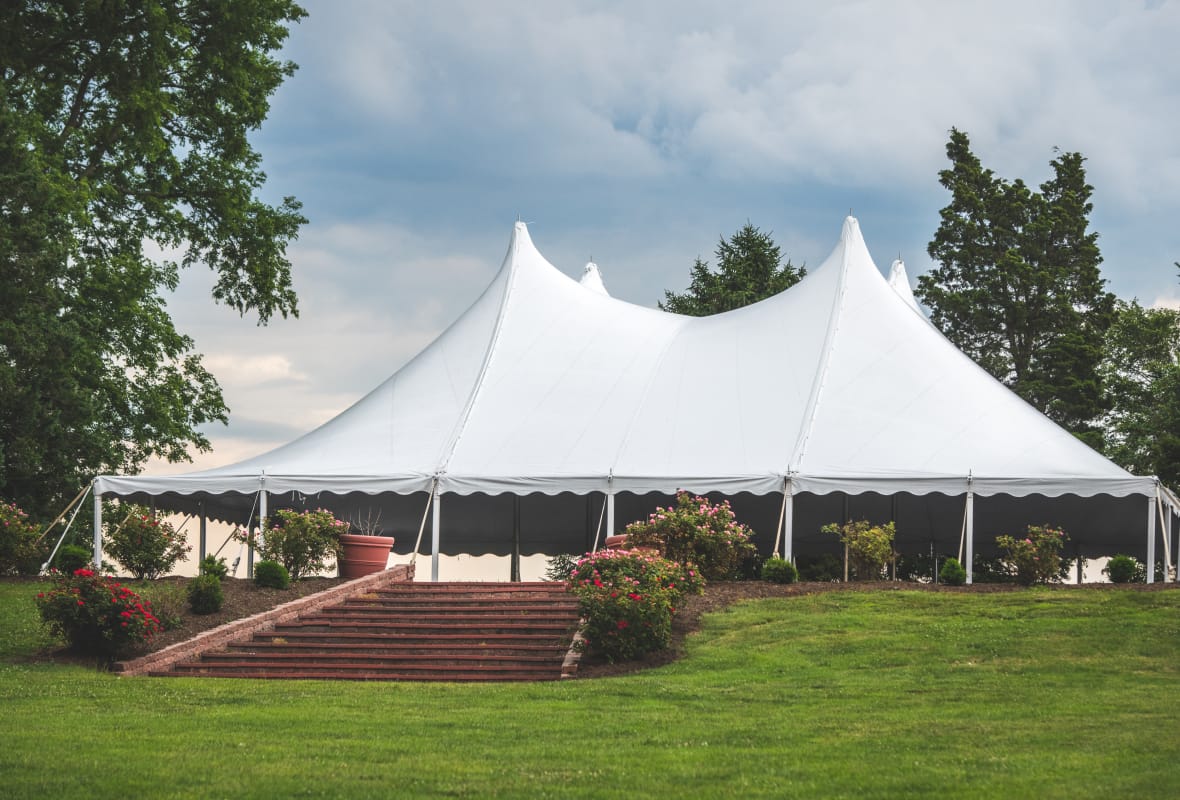 large white tent with a manicured lawn