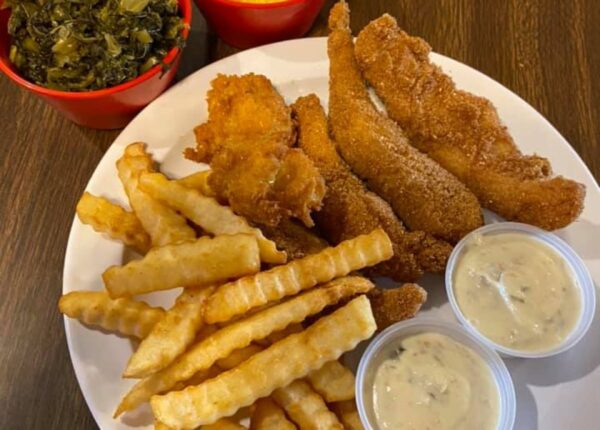 fish and chips with tarter sauce and a side of collard greens
