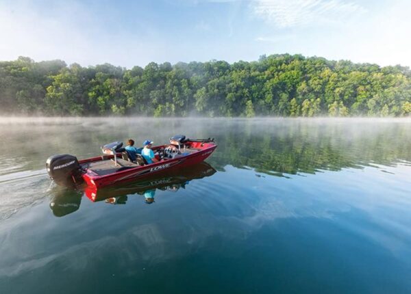 fishing boat cruising on a foggy lake